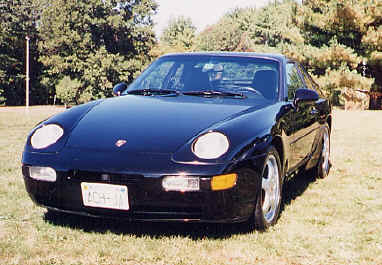 Dick Minesinger
"A total of 12,779 model 968 cars were built. During the production years, 2,417 coupes, model years 1992-1995, were sold in the US. Mine is a '93 black/black coupe which I purchased used in 1996, now with 72,000 miles.

This car has the Sport Chassis option, originally to be designated P30 and available on 1992 models, but actually delayed until the 1993 model year and then called the M30 option. The option includes bigger stabilizer bars, bigger cross-drilled brake discs, adjustable shocks, and 17" wheels. A further option is the limited slip differential. It is essentially track ready.

The engine represents a further development of what had been the 944 S2 engine: 3.0 liter, 4-cylinder, 16 valve, developing 236 HP and 225 ft-lbs of torque.

I love the car. I have frequently run it on race circuits in the US and Canada in DE events sponsored by PCA and trackmasters. It is comfortable for lengthy road trips; it has run in rallies; and it has even done well in the occasional concours. Right now, it is stored for the winter, never having seen a snow flake." - Dick
